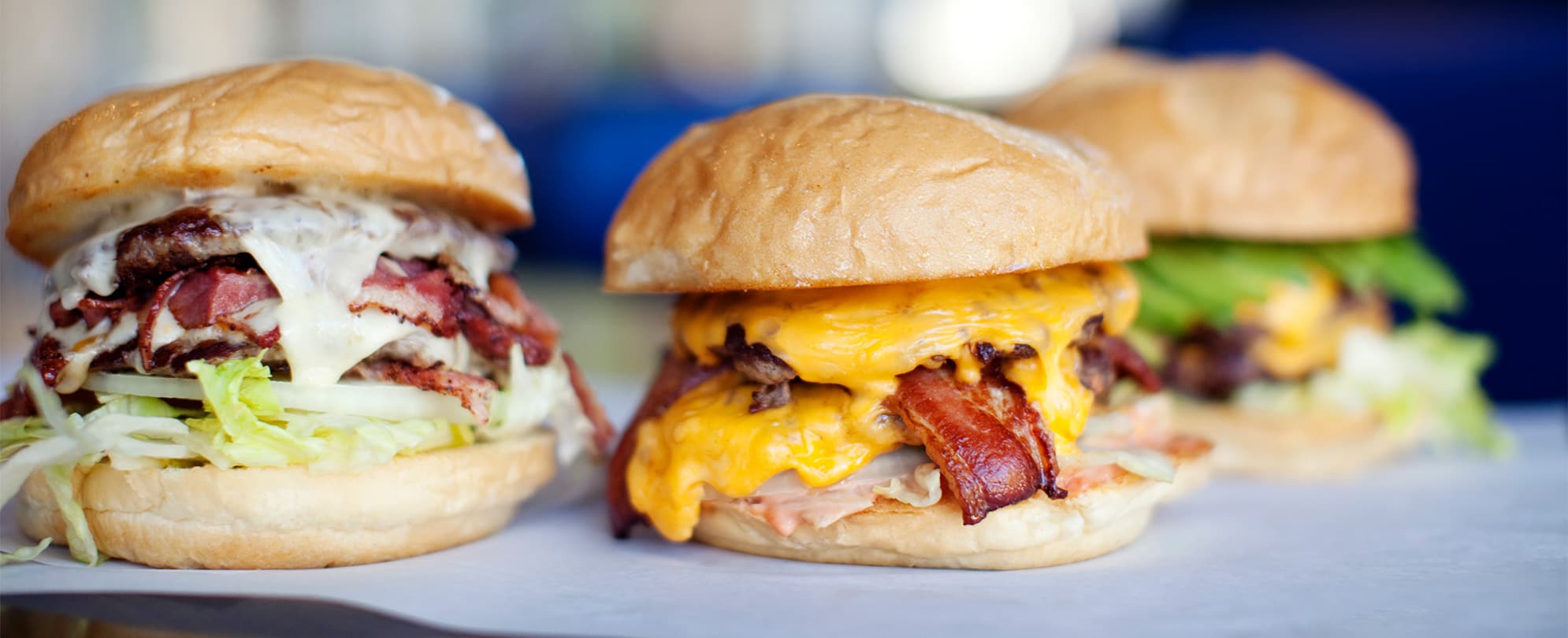 Three burger sliders with cheese, bacon, and other toppings at Mel's Hard Luck Diner, a Branson, Missouri, restaurant.