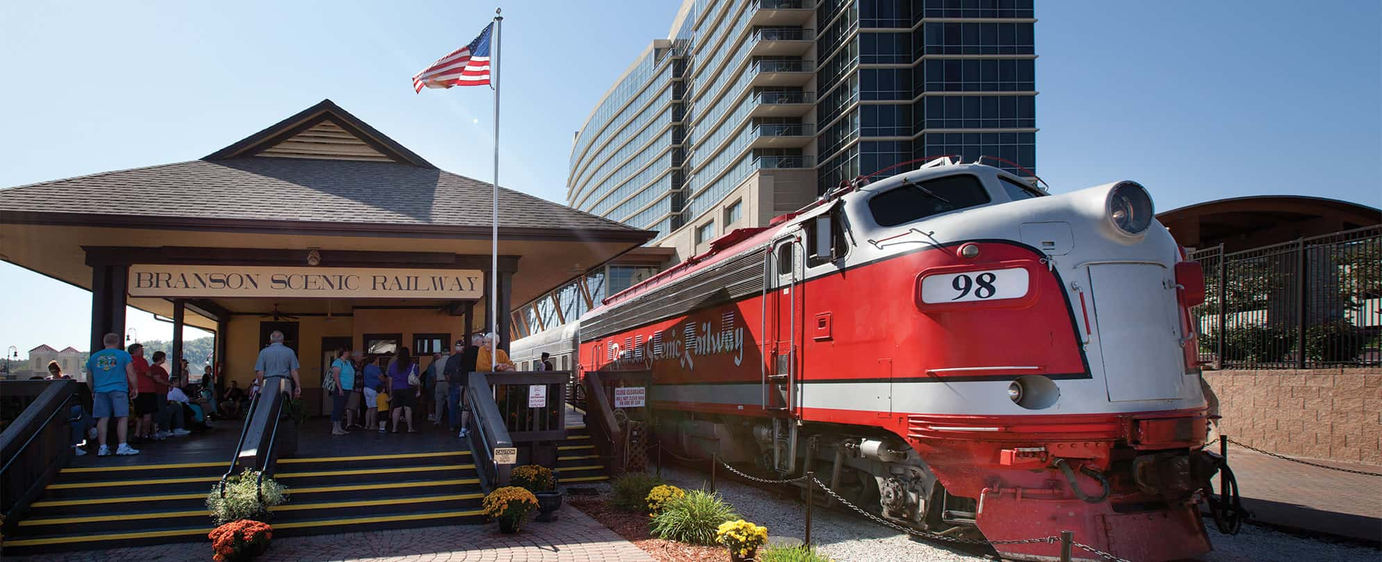 A train sitting at a station on the Branson Scenic Railway.