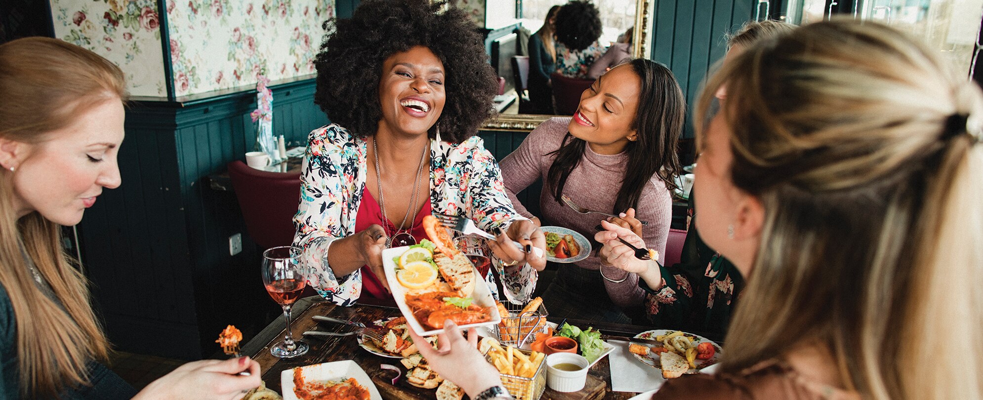 A group of women enjoy food and drinks on Restaurant Row in Orlando, Florida.