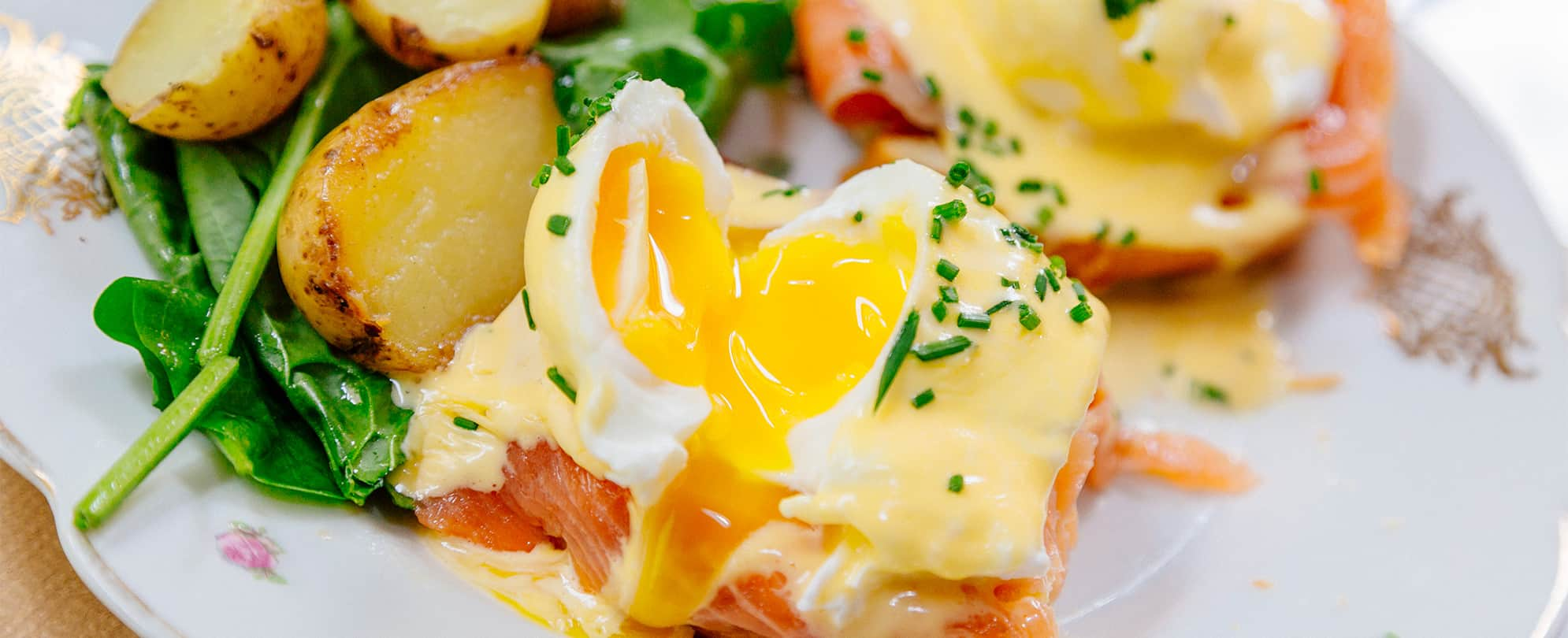 Eggs Benedict with potatoes and greens at a restaurant in Park City, Utah. 