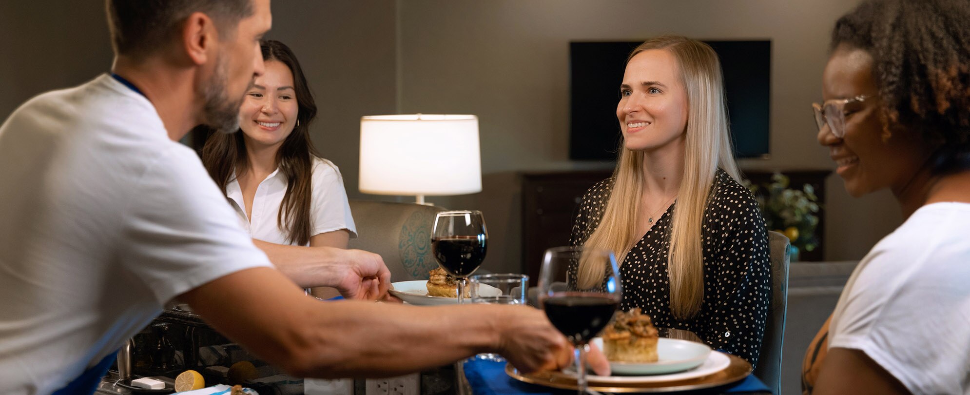 Three women get served a meal from a private chef at their Club Wyndham resort.