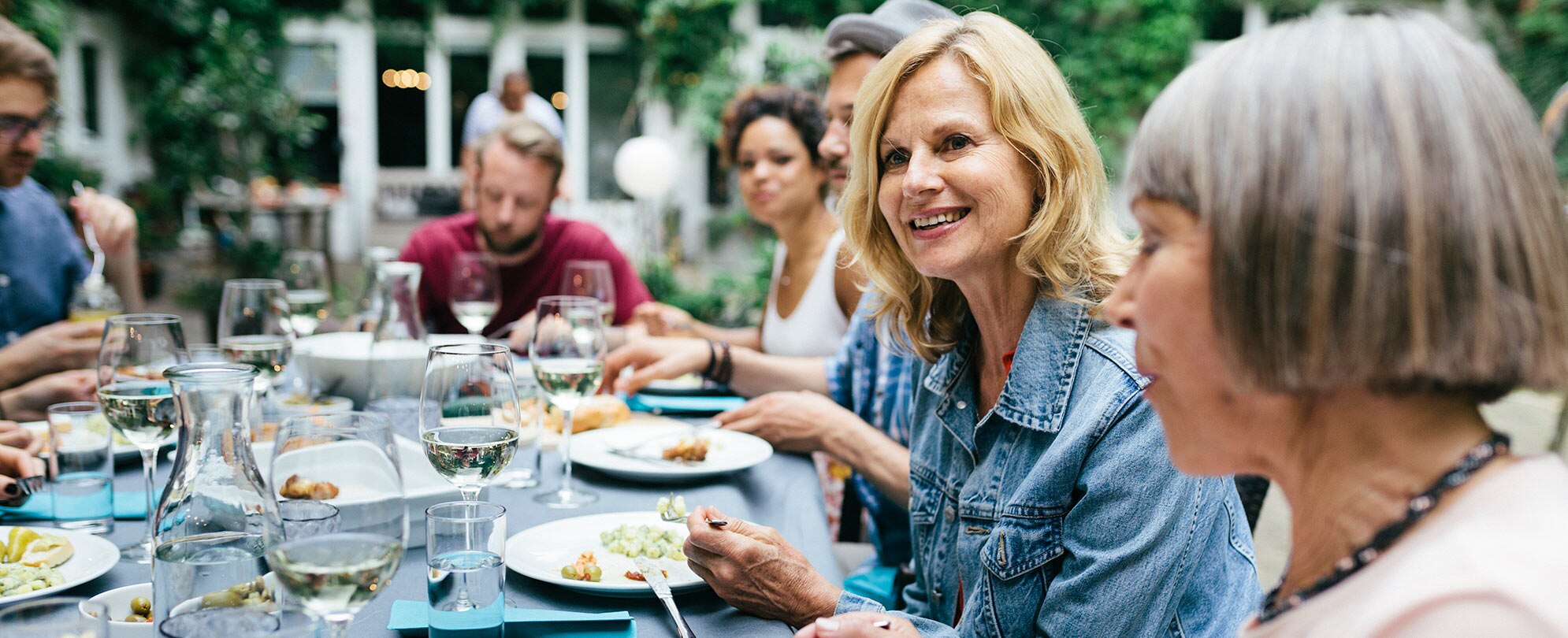 A group of people dining at a table outside