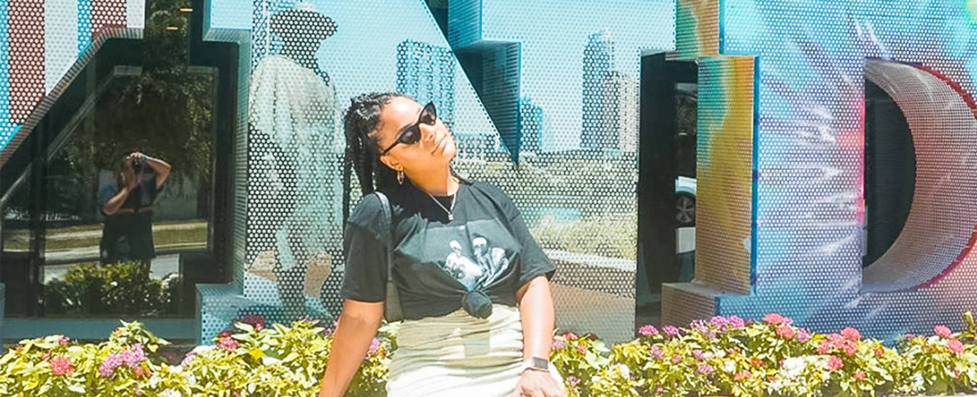 A woman poses in front of the Wyndham sign at Club Wyndham Austin in Texas